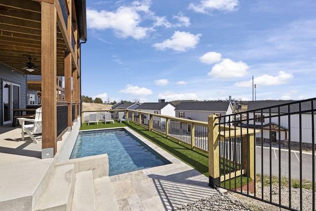 view of swimming pool with ceiling fan and a patio area