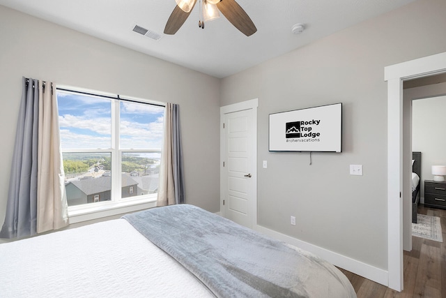 bedroom with hardwood / wood-style flooring and ceiling fan