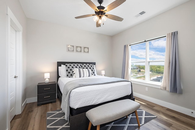 bedroom with ceiling fan and dark wood-type flooring