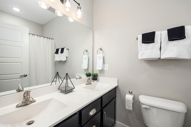 bathroom with vanity, toilet, and a shower with shower curtain