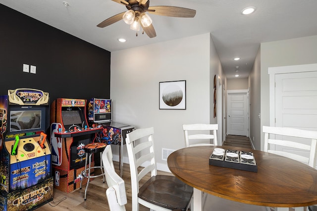 dining area featuring hardwood / wood-style floors and ceiling fan