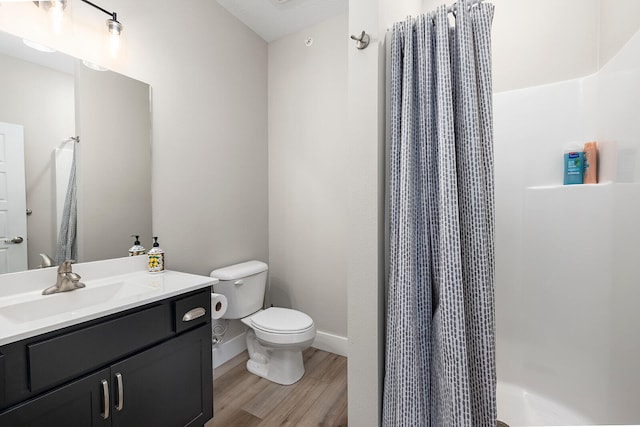 full bathroom featuring vanity, hardwood / wood-style flooring, toilet, and shower / tub combo with curtain