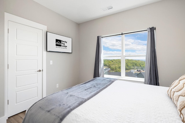 bedroom with hardwood / wood-style flooring