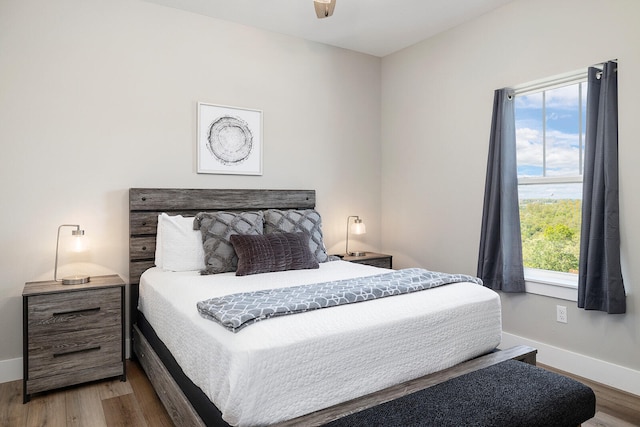 bedroom featuring hardwood / wood-style flooring and ceiling fan