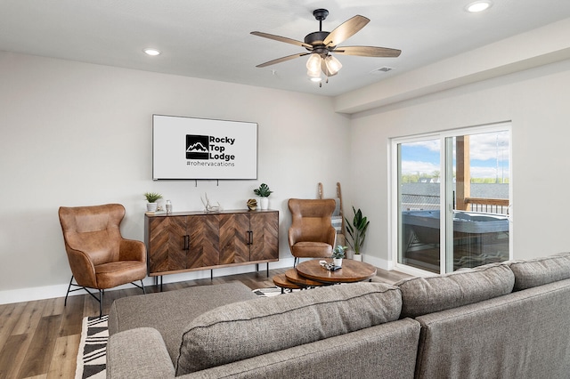 living room with hardwood / wood-style flooring and ceiling fan