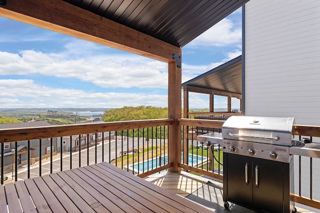 wooden terrace featuring a grill and a pool