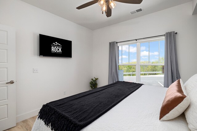 bedroom with light hardwood / wood-style flooring and ceiling fan