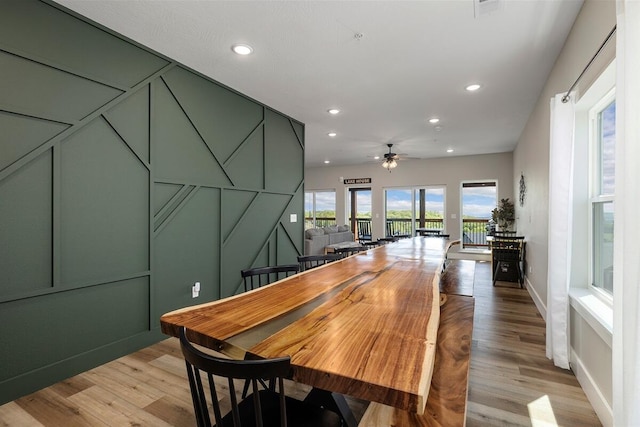 dining room with light hardwood / wood-style flooring and ceiling fan