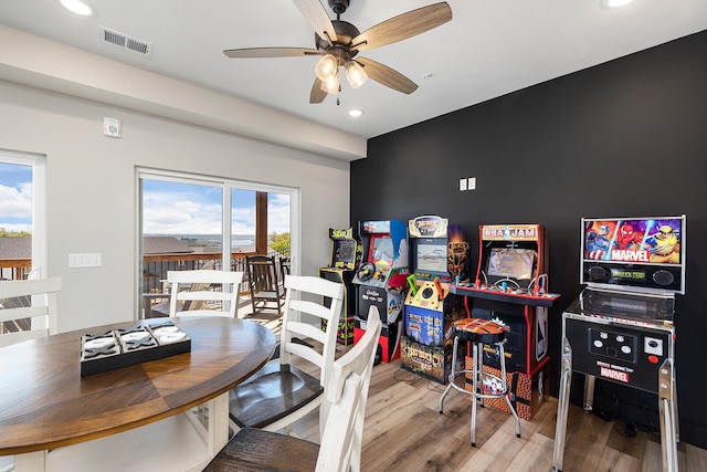 dining space with ceiling fan, plenty of natural light, and hardwood / wood-style floors