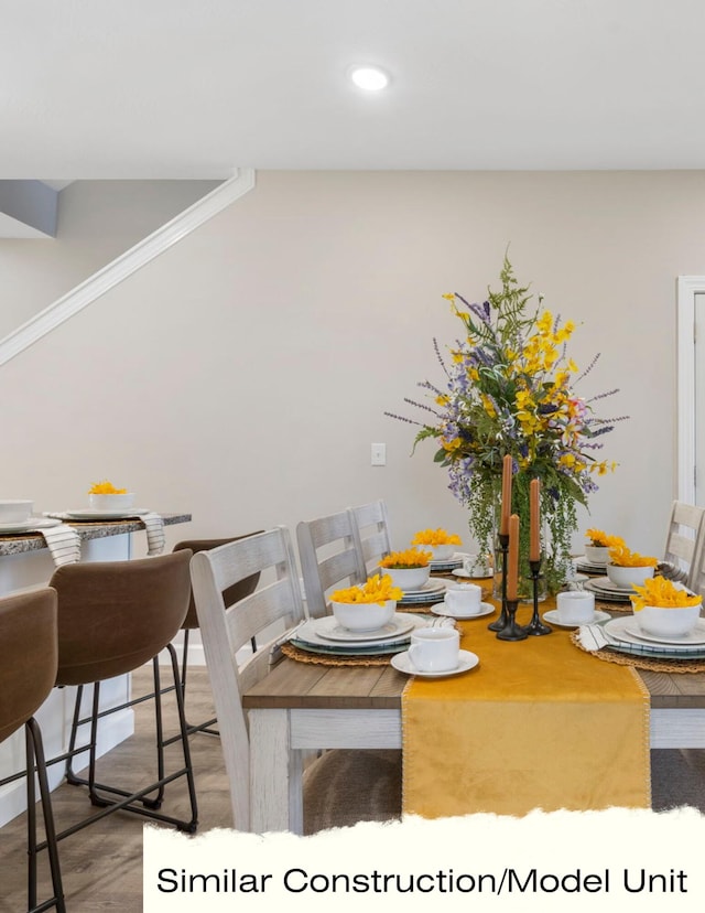 dining room with recessed lighting, wood finished floors, and crown molding