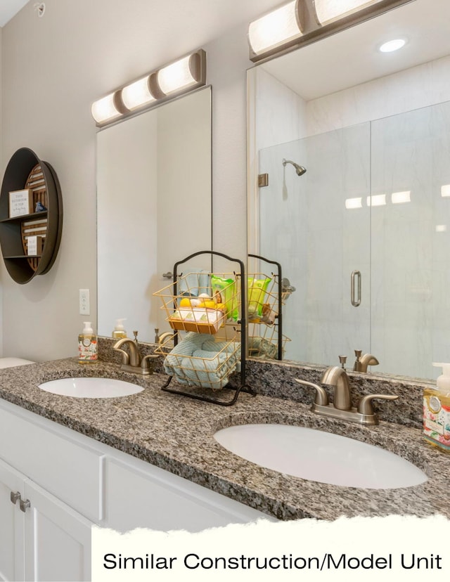 bathroom featuring walk in shower and vanity