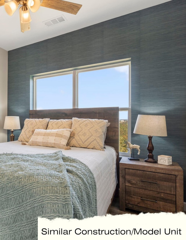 bedroom with a ceiling fan and visible vents