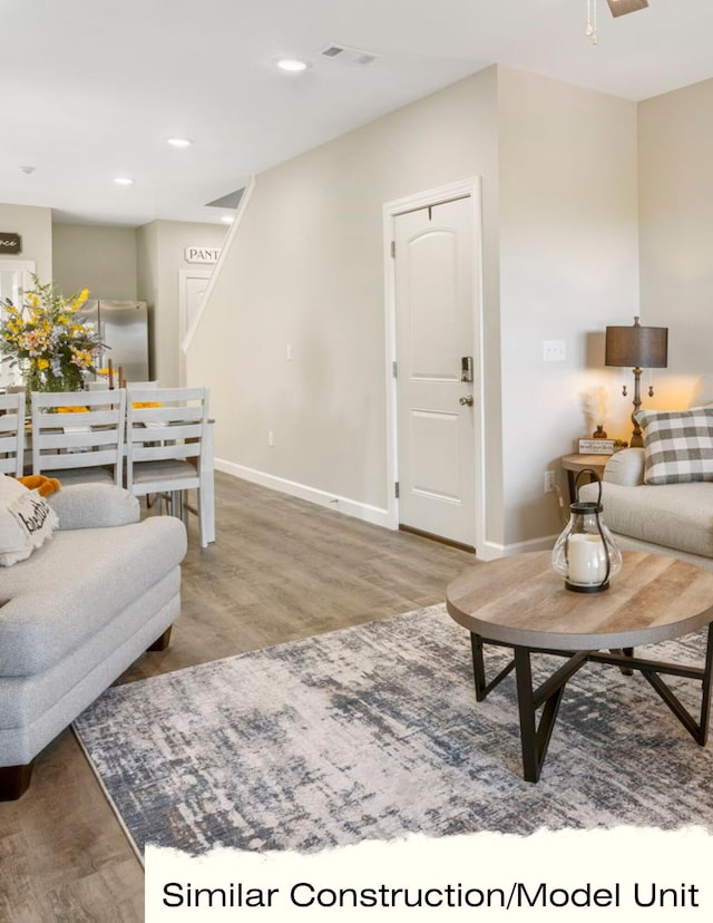 living room featuring a ceiling fan, wood finished floors, baseboards, visible vents, and recessed lighting