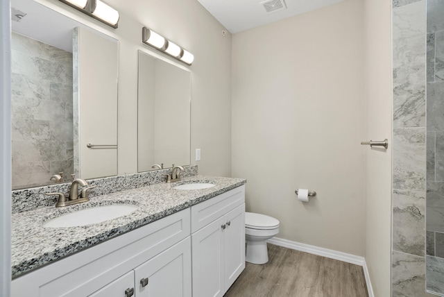 bathroom with vanity, toilet, and hardwood / wood-style flooring