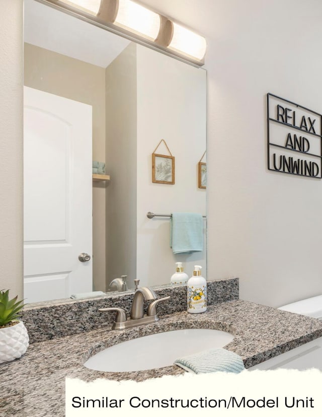 half bath featuring toilet and vanity