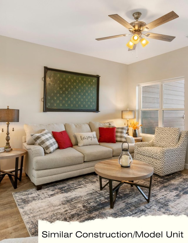 living room with wood finished floors and ceiling fan