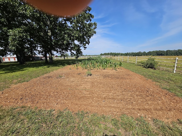 view of yard with a rural view and fence