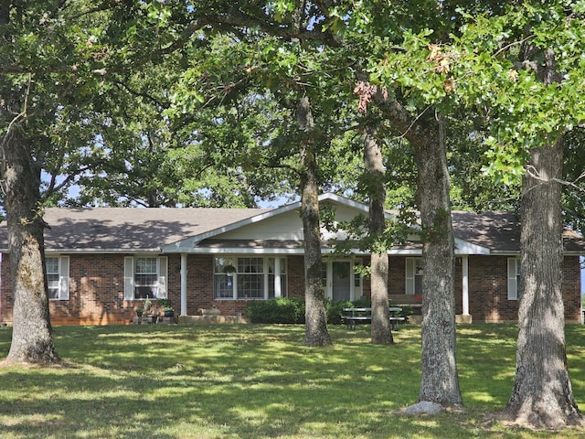ranch-style home featuring brick siding and a front yard