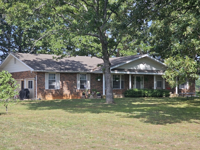 single story home featuring a front lawn and brick siding