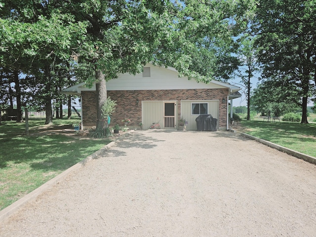 view of front of home with a front lawn and brick siding