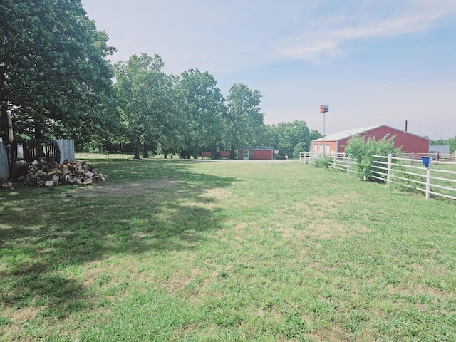 view of yard with an outdoor structure, an outbuilding, and fence