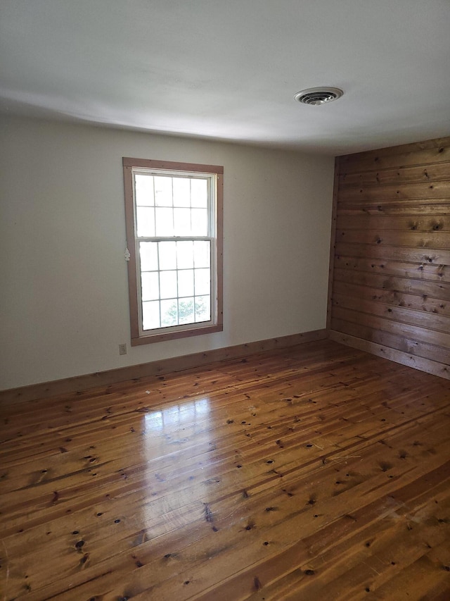 spare room with wood-type flooring and visible vents