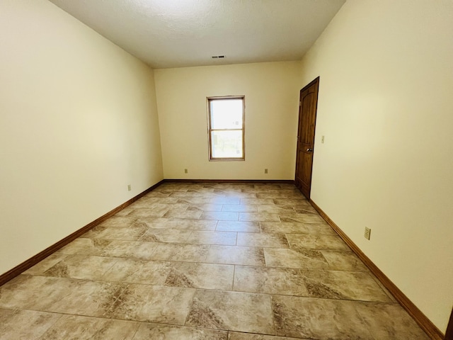 spare room with visible vents and baseboards