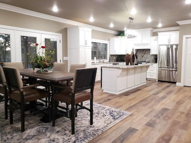 21942 Mill Creek Cir, Shell Knob, MO 65747 - kitchen with a center island, tasteful backsplash, light wood-style floors, high end fridge, and ornamental molding