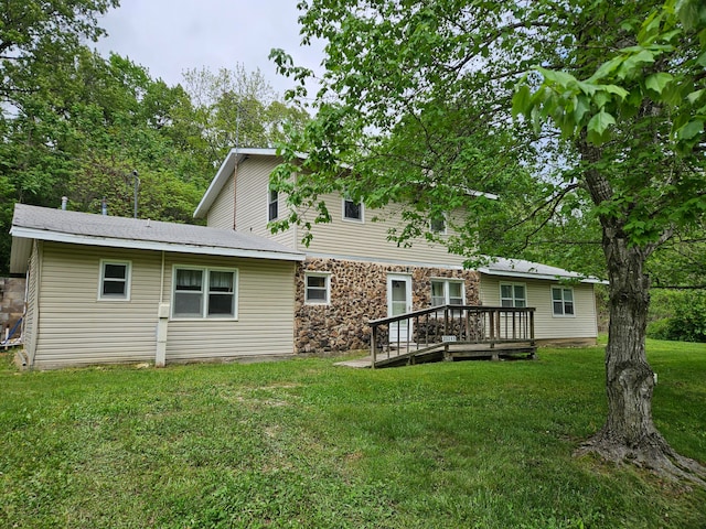 rear view of property with a yard and a wooden deck