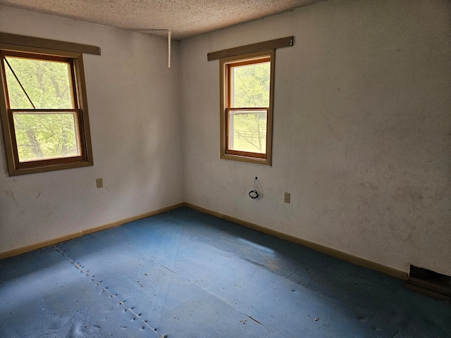 spare room featuring a textured ceiling