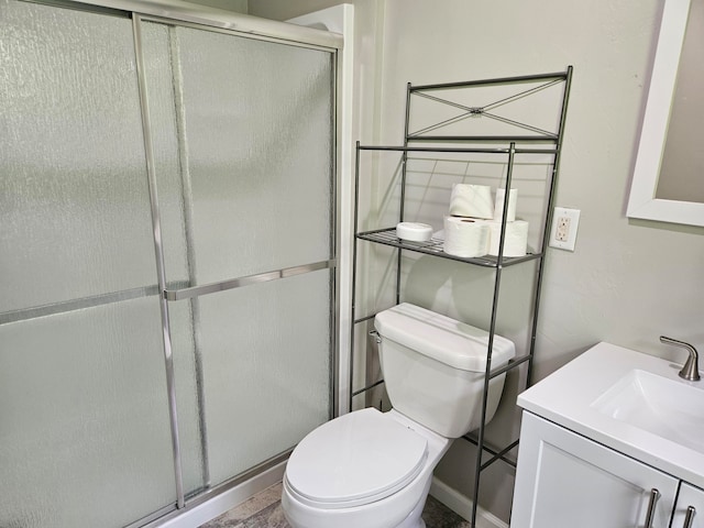 bathroom featuring an enclosed shower, toilet, and vanity