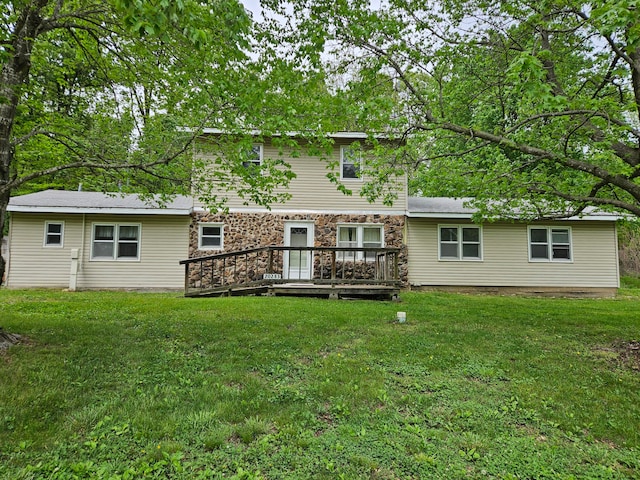 back of house featuring a yard and a deck