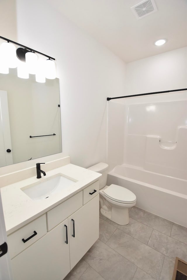 full bathroom featuring tile patterned flooring, bathtub / shower combination, vanity, and toilet