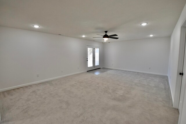 carpeted empty room with french doors and ceiling fan