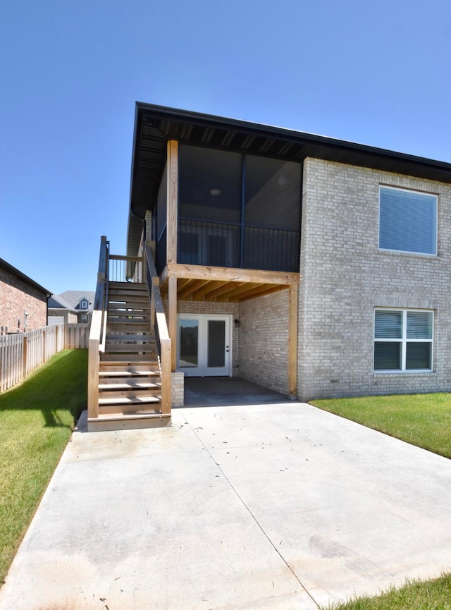 back of house featuring a yard and a patio