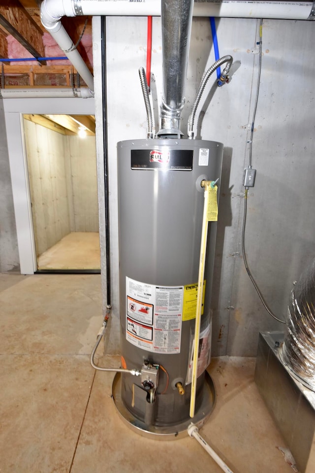 utility room featuring water heater