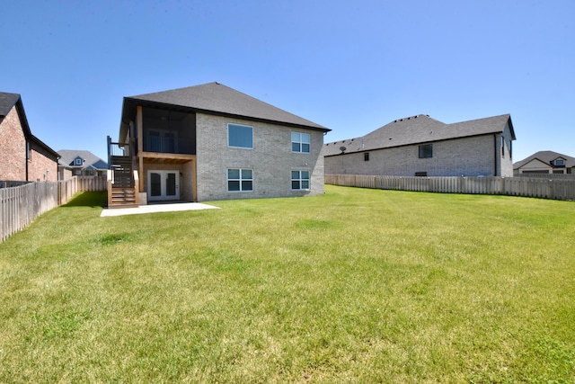 back of property featuring a yard and a patio