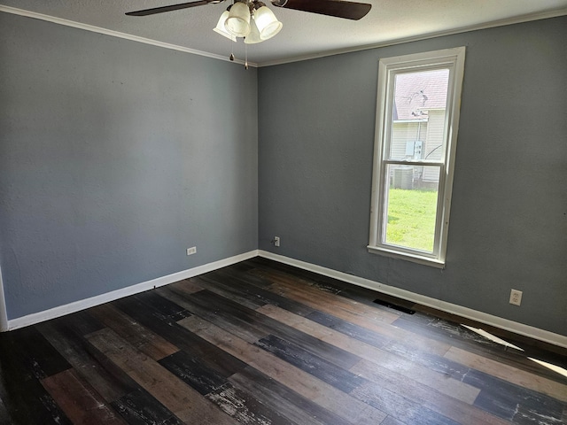 empty room featuring ornamental molding, ceiling fan, and dark hardwood / wood-style flooring