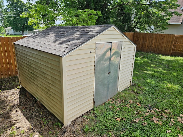 view of outbuilding featuring a yard