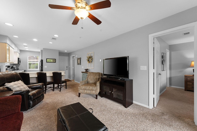 living room with light carpet and ceiling fan