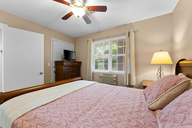 bedroom featuring an AC wall unit and ceiling fan