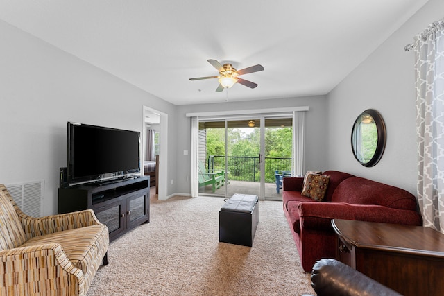 carpeted living room with ceiling fan