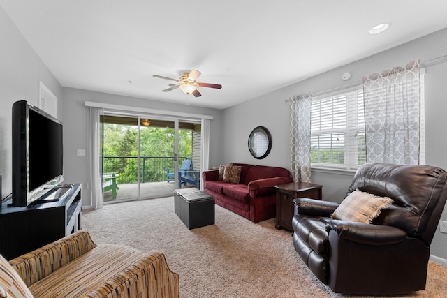 living room featuring carpet floors, plenty of natural light, and ceiling fan