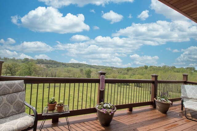 wooden deck featuring a yard