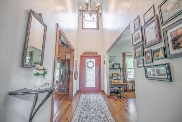 foyer entrance featuring an inviting chandelier and light hardwood / wood-style flooring