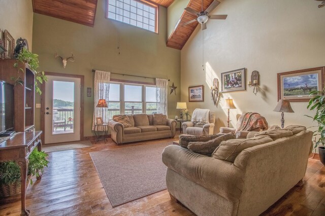 living room featuring ceiling fan, high vaulted ceiling, wood ceiling, and hardwood / wood-style floors