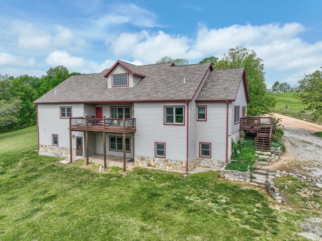 back of house featuring a wooden deck and a lawn