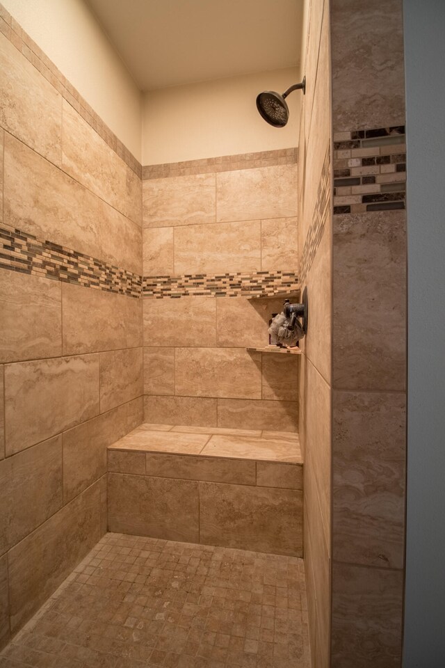 bathroom with a tile shower