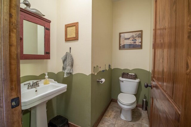 bathroom featuring tile patterned floors, sink, and toilet