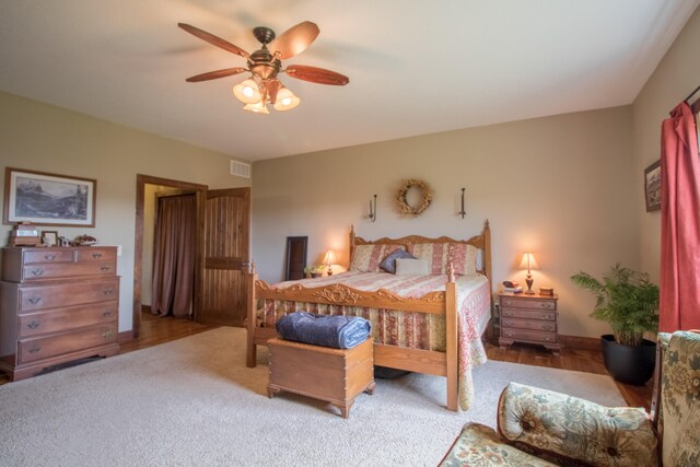 bedroom with ceiling fan and hardwood / wood-style flooring